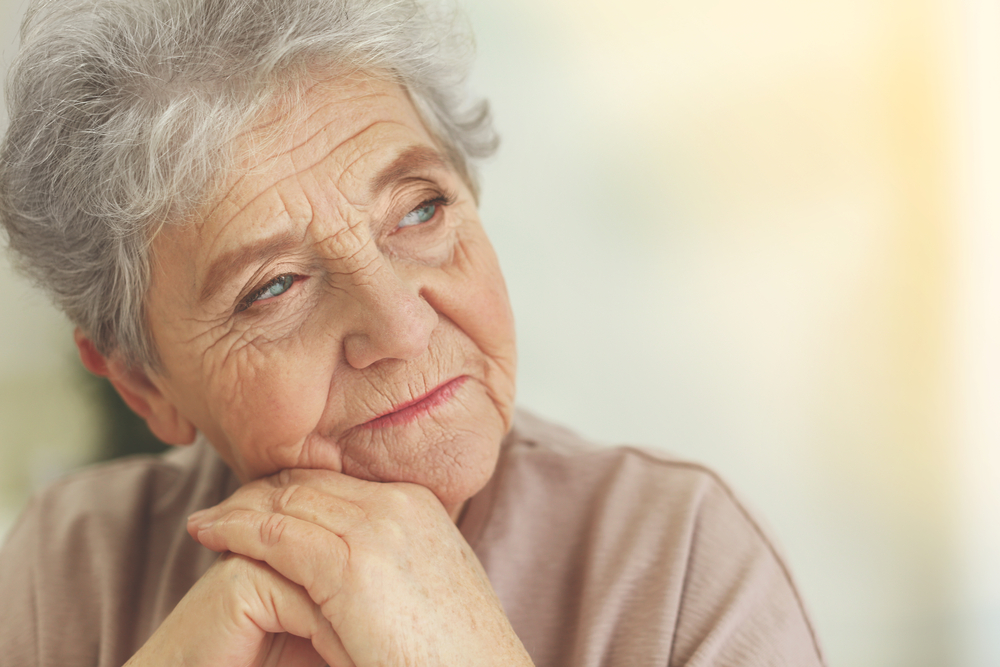 Mental wellness: Elderly woman looking contemplative