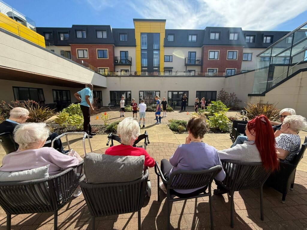 Residents watching the junior footballers