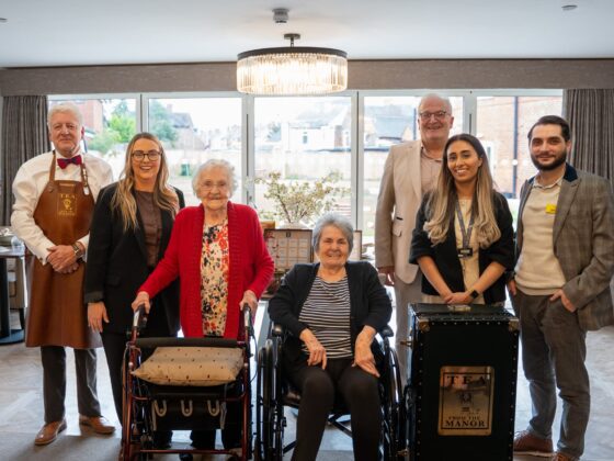 Carers, residents and teamakers pose for a group shot