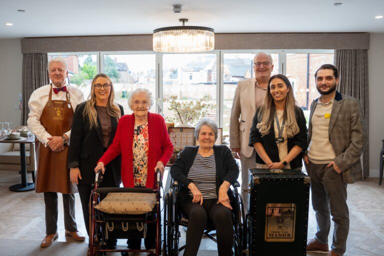Carers, residents and teamakers pose for a group shot